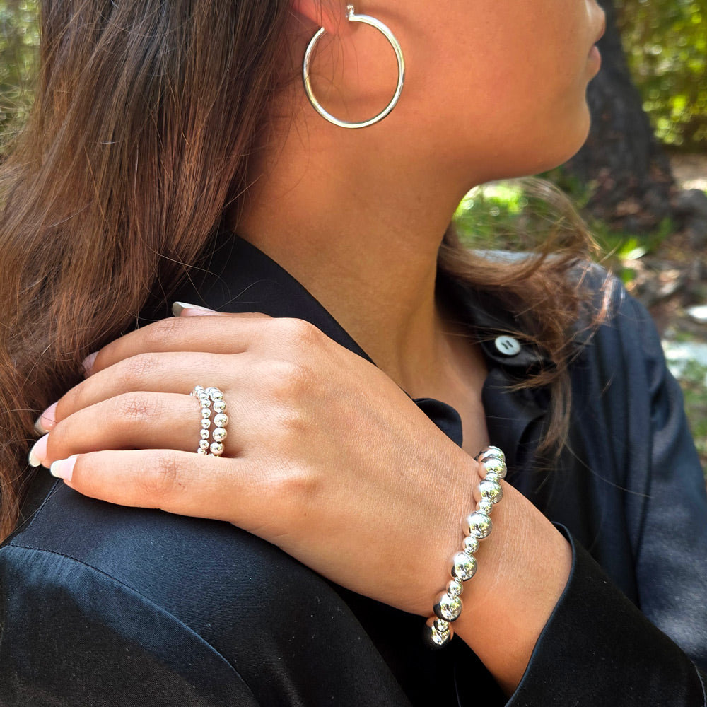 Sterling silver jewelry including large hoop earrings, stacked ring set and stretch to fit sterling bracelet