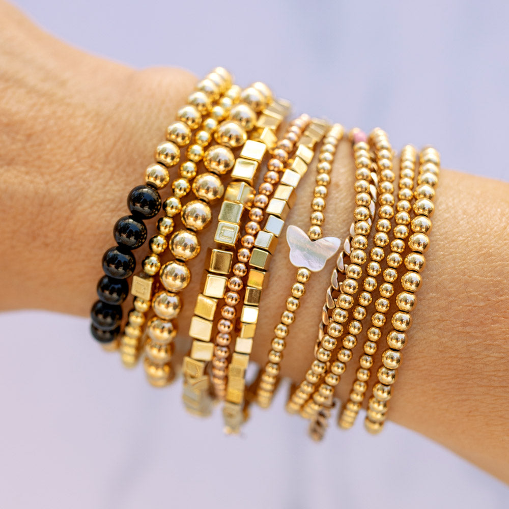 Onyx and 14k Gold Bead Stretch-to-Fit Bracelet stacked with 3mm 14k Gold Filled Bracelets with Crystal Butterfly