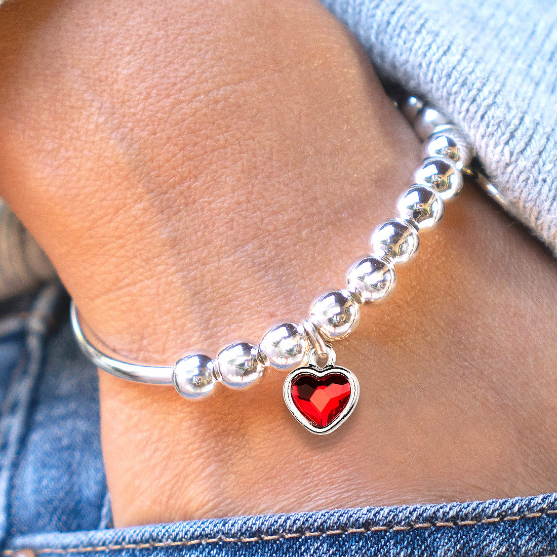 Ruby Crystal Silver Heart Charm shown on the Lori silver bracelet